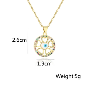 Detail of 18K gold evil eye pendant with measurements 2.6cm by 1.9cm and weight 5g
