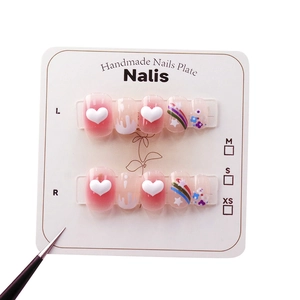 Handmade press-on nails with 3D hearts, rainbows and flowers on pink gradient base