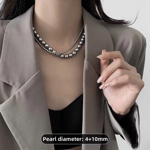 Detail showing layered gray faux pearl necklace with 4mm and 10mm beads on model
