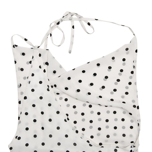Detail of white polka dot dress featuring a backless halter neck and wrap V-neckline