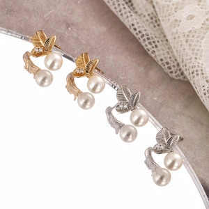 Three-leaf pearl studs with cubic zirconia in gold and silver plating on lace background