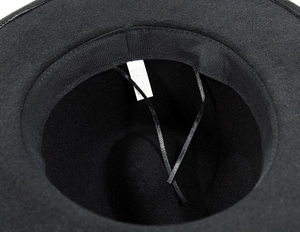 Detail view of the fedora inner band with adjustable strap and material care label