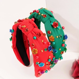 Detail of red and green knotted fabric headbands with beads, rhinestones and metal roses