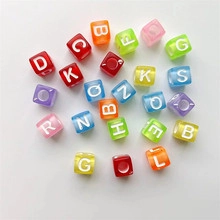 Close-up of colorful square acrylic alphabet beads with white letters for DIY jewelry
