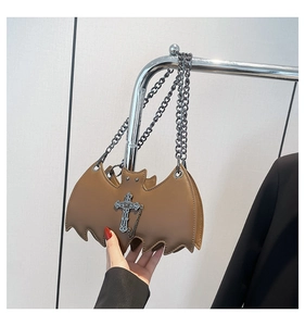 Brown leather bat-shaped bag featuring a metal cross pendant and sleek chain strap