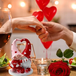 Romantic Valentine Gnomes figurines holding Love heart on rose base with dinner background