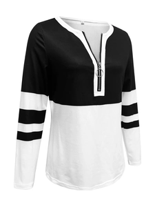 Close-up of the V-neck with metal zipper and ring puller on striped patchwork sweatshirt