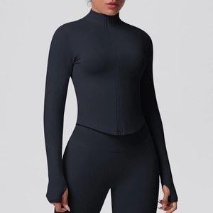 Close-up of black ribbed yoga jacket featuring thumb holes and high collar zipper detail