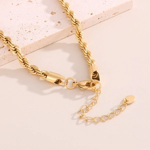 Gold vacuum-plated stainless steel twist chain necklace with lobster clasp on stone
