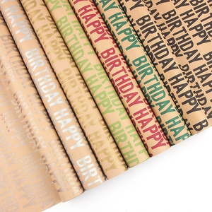 Rolls of vintage kraft Happy Birthday wrapping paper in multiple metallic colors