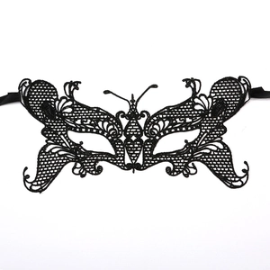 Intricate black lace butterfly mask featuring detailed hollow patterns and ribbon ties