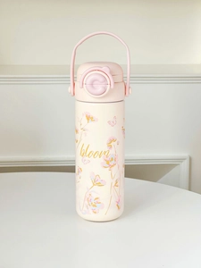 Pink stainless steel water bottle with bloom floral print and portable handle detail