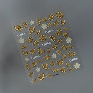 Detailed view of 3D lemon nail stickers with citrus slices and white floral patterns