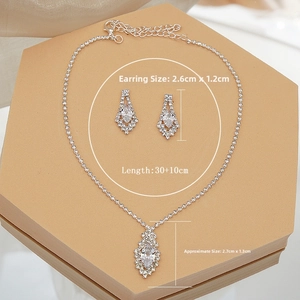 Detail of zircon necklace and earring set with diamond-shaped pendants for bridal wear