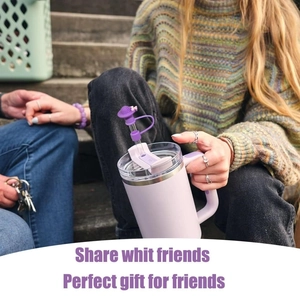 Lilac 40oz insulated tumbler with matching butterfly straw cover in an outdoor setting