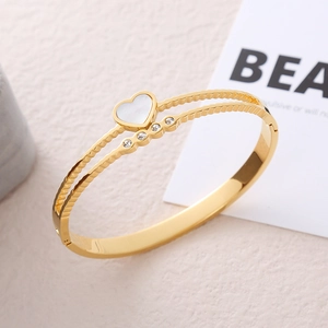 Golden heart shell bangle with cubic zirconia and textured stainless steel finish