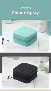 Detail of square cross-grain PU leather jewelry cases in mint green and black colors