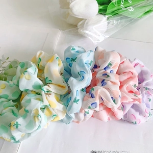 Set of 5 colorful elastic hair scrunchies with vibrant fruit patterns on soft fabric