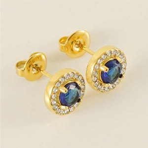Macro detail of 18K gold-plated double-layer earrings with blue stone and cubic zirconia
