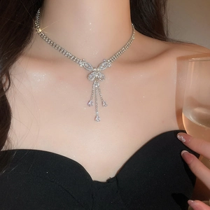 Elegant silver butterfly tassel necklace with sparkling zircon on a female model