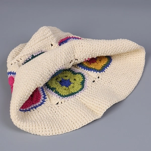Close-up of handmade crochet bucket hat with colorful flower patterns and woven texture