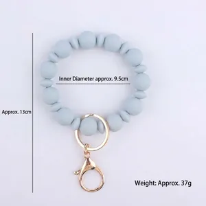 Portachiavi a bracciale con perle di silicone azzurro con anello in metallo dorato
