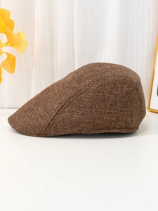 Close-up of the brown breathable linen fabric texture on the vintage flat cap
