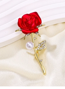 Detailed view of elegant red rose brooch with gold stem, sparkling crystals, and white pearl