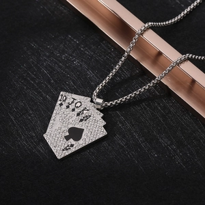 Macro detail of silver royal flush poker pendant with sparkling zircon inlays and box chain