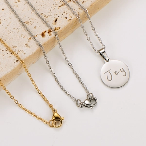 Minimalist 18k gold and silver stainless steel Joy round pendant necklaces on stone base