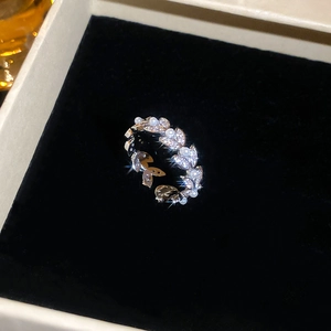 Macro view of olive leaf ring with pearls and zircons in a jewelry gift box