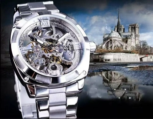 Detailed macro view of silver hollow mechanical watch movement and roman numeral dial