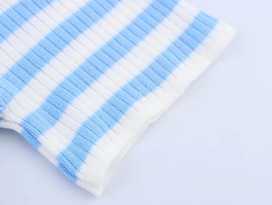 Close-up of blue and white striped knit fabric with detailed ribbed texture and quality weave