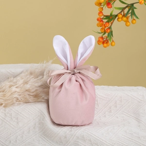 Detailed close-up of pink velvet Easter bunny ear drawstring bag with ribbon bow