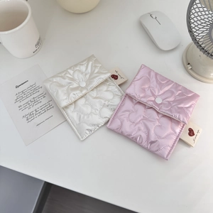Detailed top view of pink and beige heart quilted satin storage bags with button closures