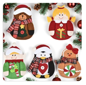 Close-up of felt Christmas cutlery holders with bear, elf, and gingerbread characters