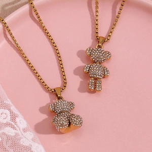 Detailed close-up of 18K gold plated chain with a crystal encrusted bear pendant on lace