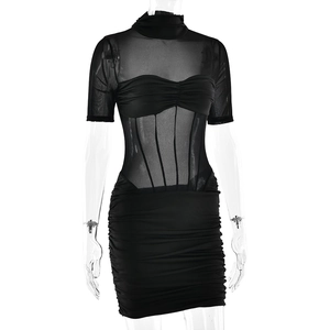 Close-up of semi-transparent mesh fabric with elegant ruching details and boning structure