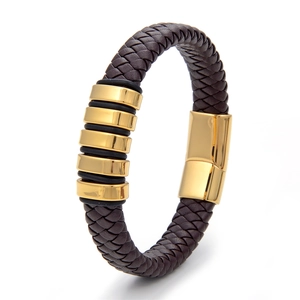Close-up of woven brown leather bracelet featuring gold metal rings and magnetic clasp