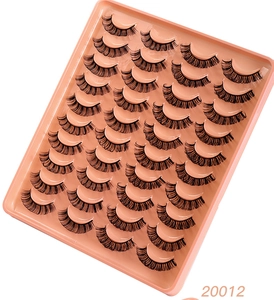 Macro view of 20 pairs of dense curly black synthetic false eyelashes in pink tray