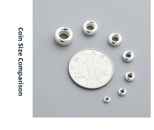 Size comparison of S925 sterling silver spacer beads with a coin on a dark background