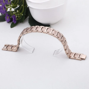 Polished rose gold titanium steel link bracelet with matte finish on curved stand
