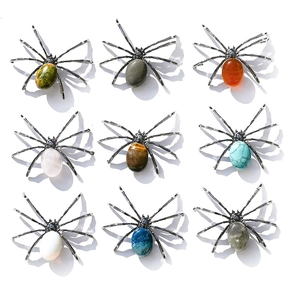 Grid display of nine spider brooches featuring various natural crystal and gemstone bodies