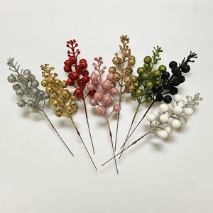 Close-up of artificial glitter berry stems in various colors for Christmas DIY crafts