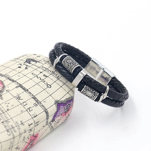 Detail of Viking double-layer woven leather bracelet with Norse rune metal beads