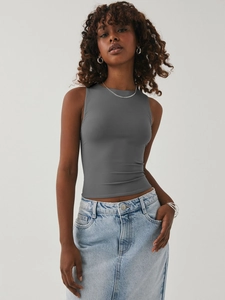 Close-up of tight-fit grey sleeveless crop top paired with a light blue denim skirt
