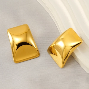 Macro shot of 18k gold plated stainless steel square earrings with convex polished surface