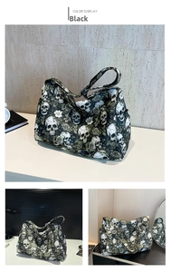 Detail view of large nylon tote bag featuring gothic skull and rose print with side pocket