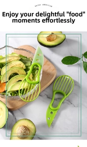 Three-in-one green avocado slicer featuring pitter and slicer tool on a marble desk