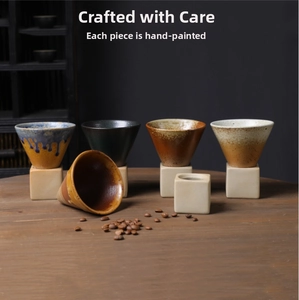 Detailed close-up of handmade cone-shaped ceramic coffee mugs with rustic textured glazes